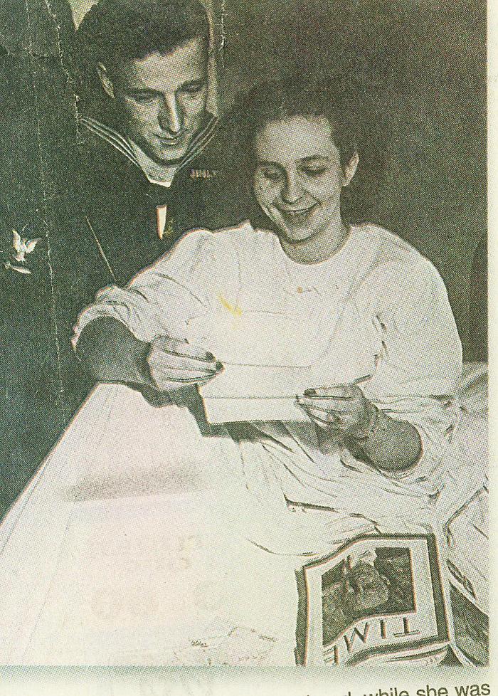 Sailor and woman looking at Time magazine and letters